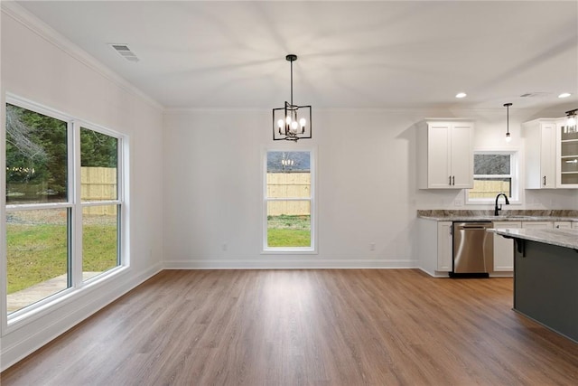 kitchen featuring decorative light fixtures, visible vents, glass insert cabinets, white cabinets, and dishwasher