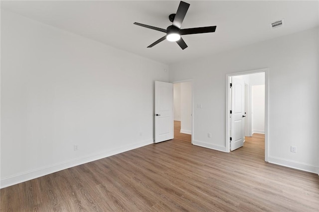 unfurnished bedroom featuring visible vents, ceiling fan, light wood-style flooring, and baseboards