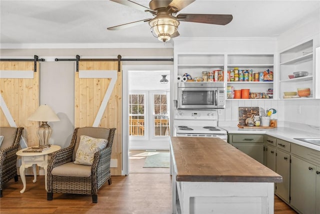 93 Parnell Rd, Abbeville, SC 29620 - kitchen featuring stainless steel microwave, white range with electric stovetop, a barn door, and butcher block countertops