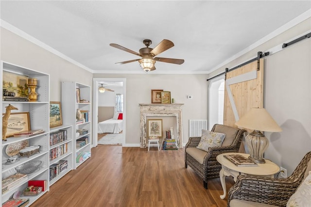 93 Parnell Rd, Abbeville, SC 29620 - sitting room featuring ceiling fan, a barn door, wood finished floors, plenty of natural light, and ornamental molding