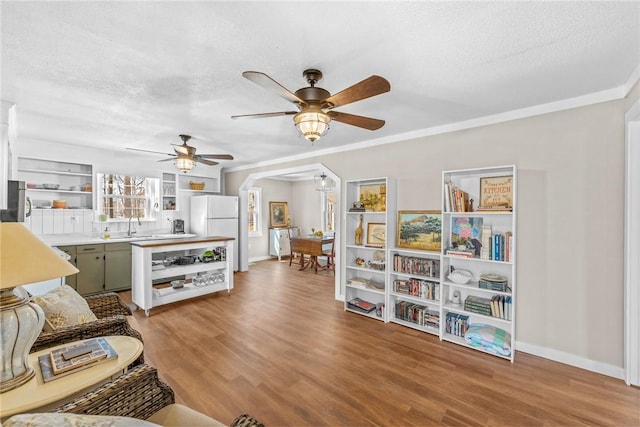 93 Parnell Rd, Abbeville, SC 29620 - living area featuring a ceiling fan, a textured ceiling, light wood finished floors, baseboards, and ornamental molding
