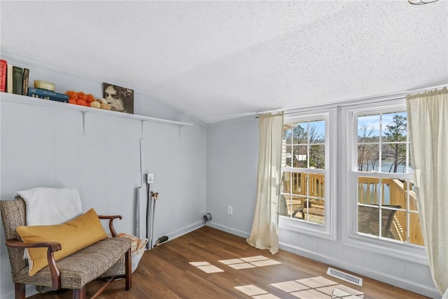 93 Parnell Rd, Abbeville, SC 29620 - living area with a textured ceiling, wood finished floors, vaulted ceiling, and baseboards