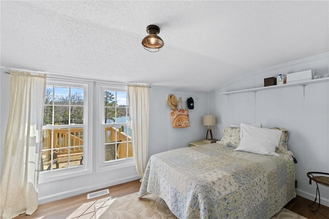 93 Parnell Rd, Abbeville, SC 29620 - bedroom with lofted ceiling, a textured ceiling, and wood finished floors