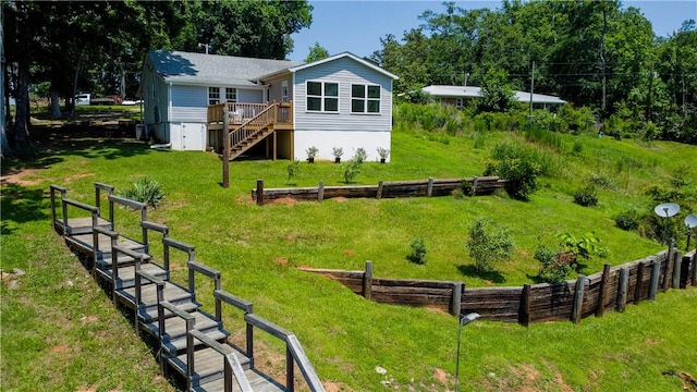 93 Parnell Rd, Abbeville, SC 29620 - back of house featuring stairs, a wooden deck, and a lawn