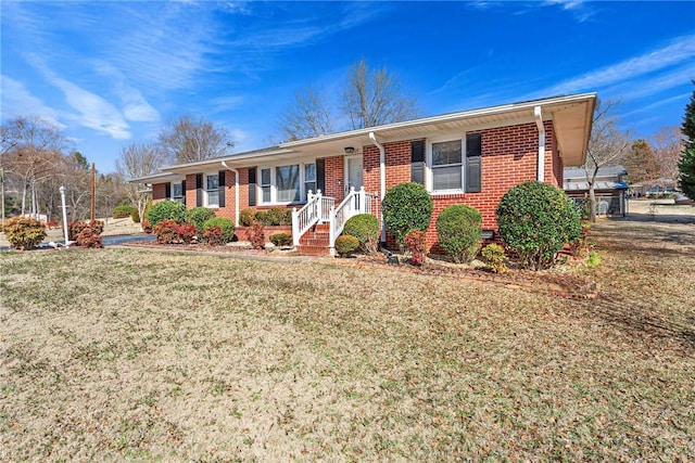 single story home with brick siding and a front lawn