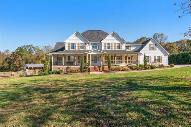 view of front of house featuring covered porch, a front lawn, and fence