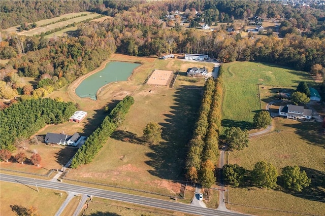 aerial view with a water view and a wooded view