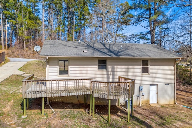 rear view of property featuring central air condition unit, a shingled roof, and a wooden deck