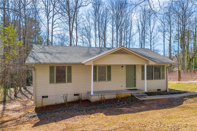 view of front of house featuring roof with shingles, a porch, crawl space, and fence