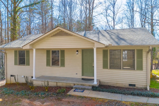 view of front of property featuring crawl space, a shingled roof, and a porch