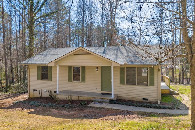 view of front of property featuring covered porch, a shingled roof, and crawl space