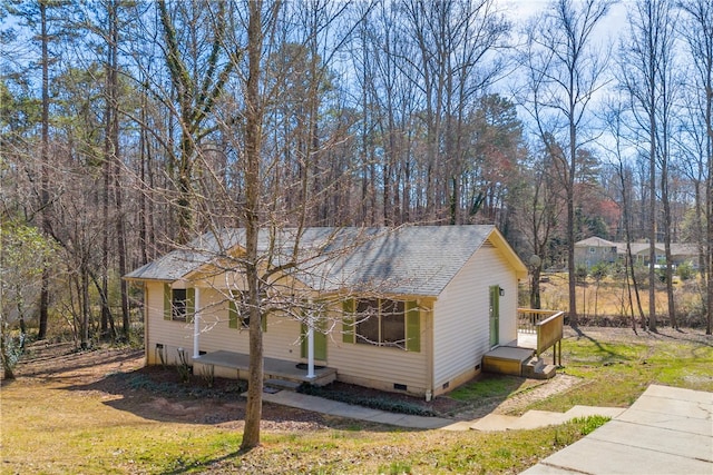 view of front of house with crawl space, a front lawn, and roof with shingles