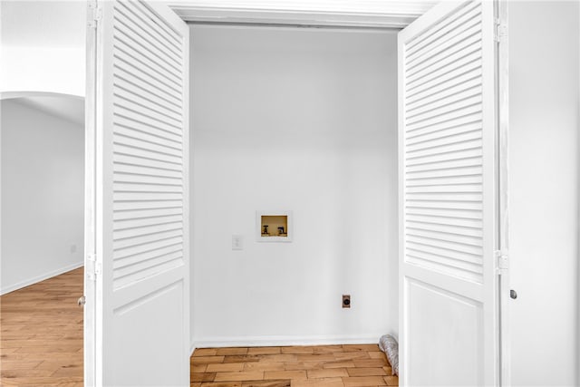 washroom featuring arched walkways, hookup for a washing machine, laundry area, light wood-style floors, and electric dryer hookup