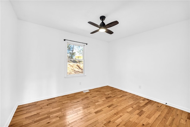 unfurnished room with baseboards, ceiling fan, visible vents, and light wood-style floors