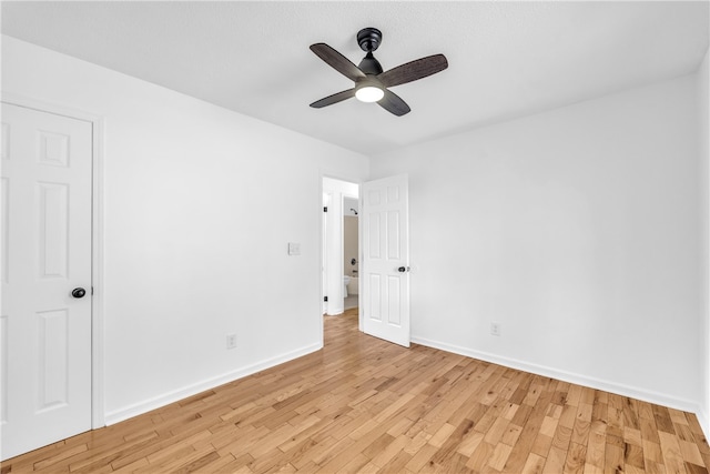 unfurnished bedroom with baseboards, a ceiling fan, and light wood-style floors