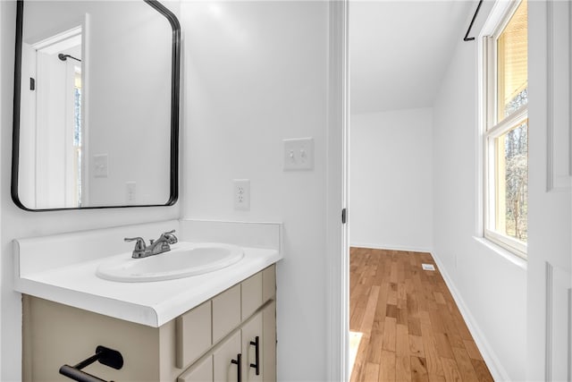 bathroom featuring wood finished floors, vanity, and baseboards