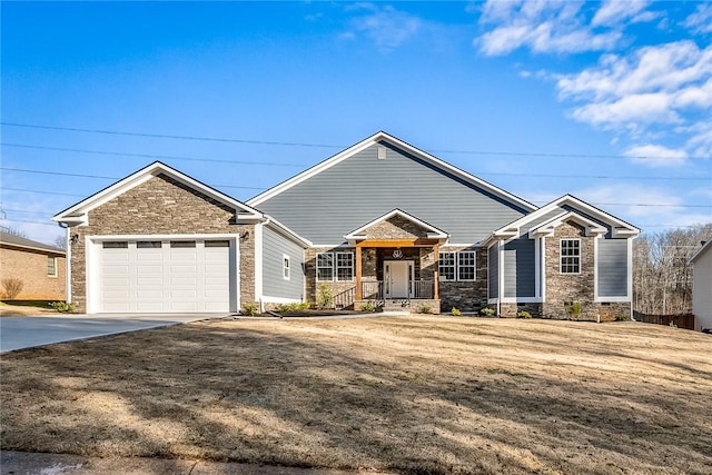 ranch-style house featuring driveway, an attached garage, and a front yard