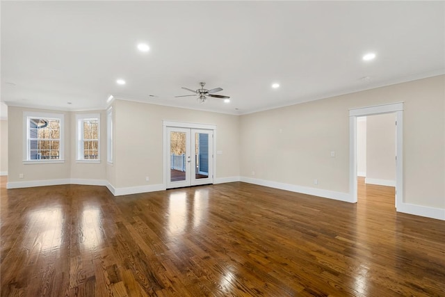 unfurnished living room with dark wood-style floors, french doors, crown molding, and baseboards