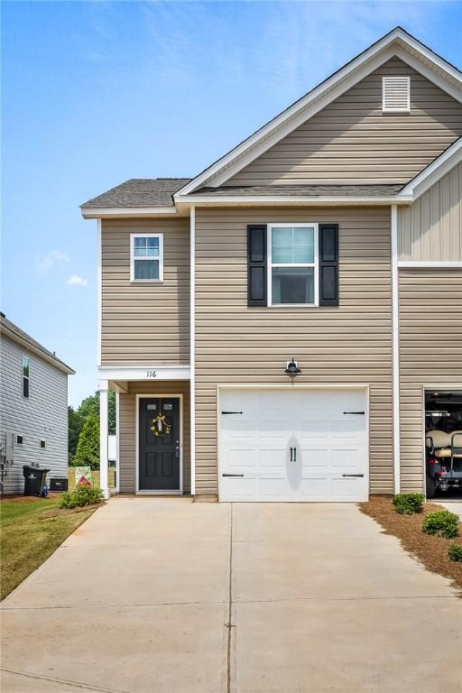 view of front of property featuring a garage and concrete driveway