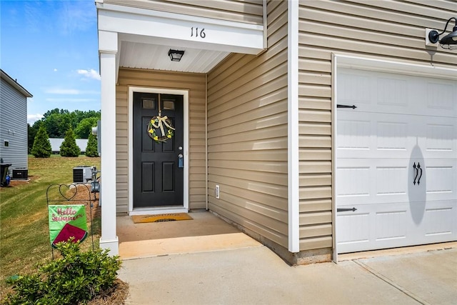 property entrance with a garage and central air condition unit