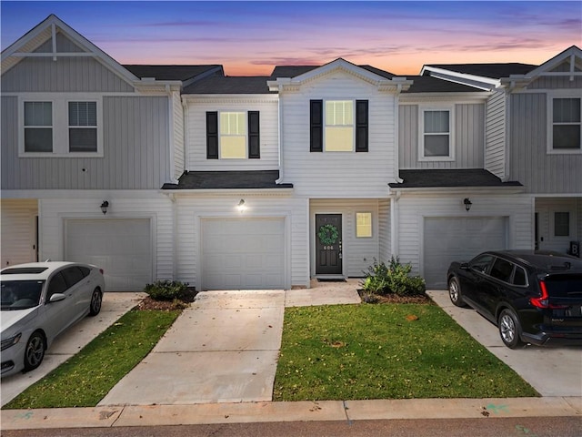 townhome / multi-family property featuring driveway and an attached garage