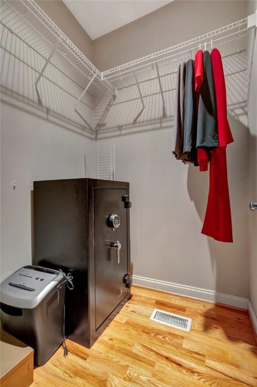 kitchen with baseboards, visible vents, and wood finished floors