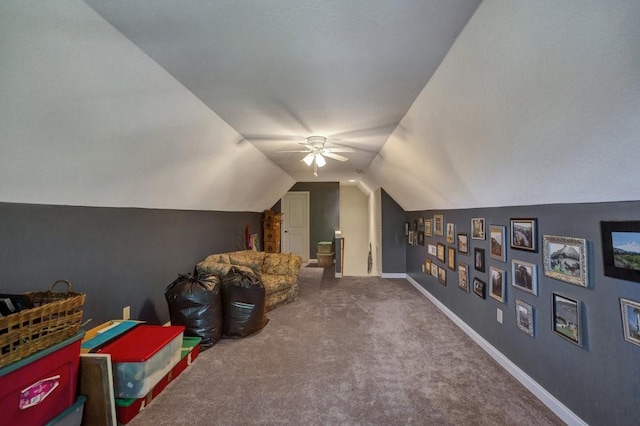 game room with carpet floors, baseboards, vaulted ceiling, and a ceiling fan