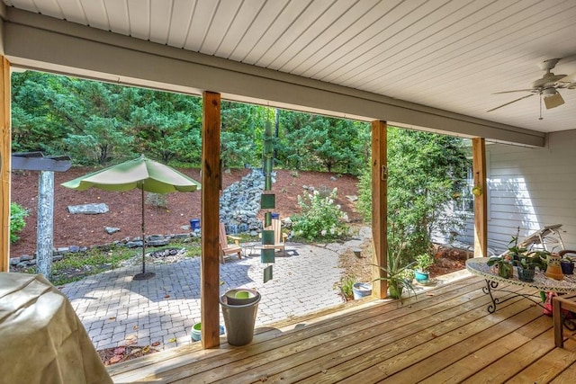 wooden deck with ceiling fan and a patio