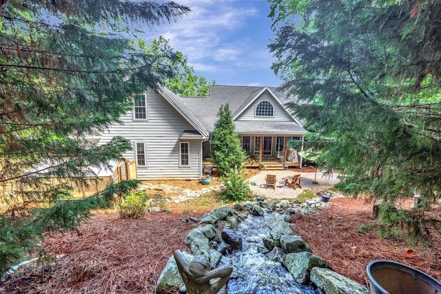 view of front of house with a patio area and fence