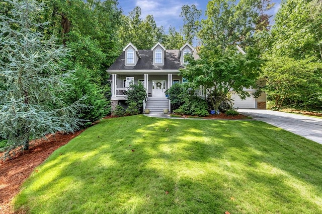 cape cod-style house featuring covered porch, concrete driveway, a front lawn, and an attached garage