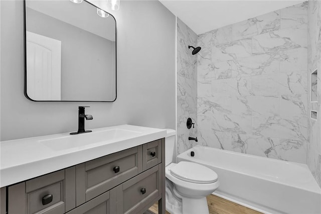 bathroom with shower / tub combination, vanity, toilet, and wood finished floors