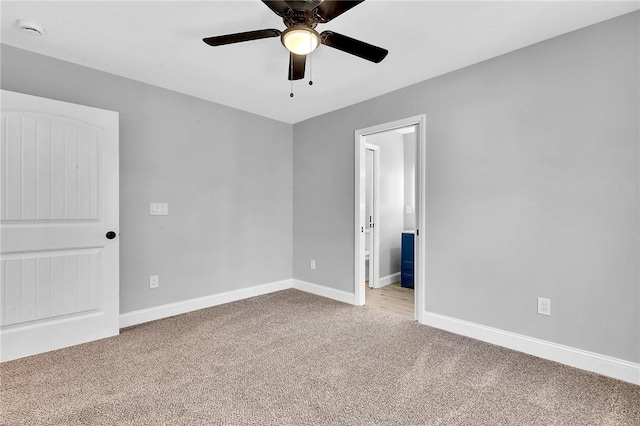 unfurnished bedroom with ceiling fan, carpet, connected bathroom, and baseboards