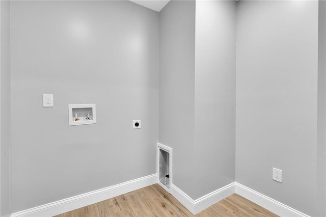 laundry area featuring hookup for an electric dryer, laundry area, washer hookup, baseboards, and light wood finished floors