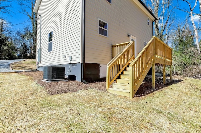 exterior space with stairs, a deck, and cooling unit