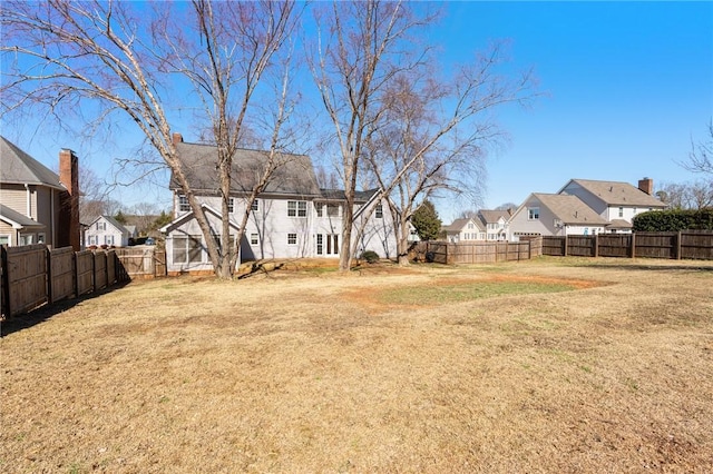 view of yard featuring a residential view and a fenced backyard