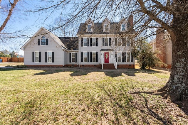 view of front facade with a chimney, crawl space, and a front yard