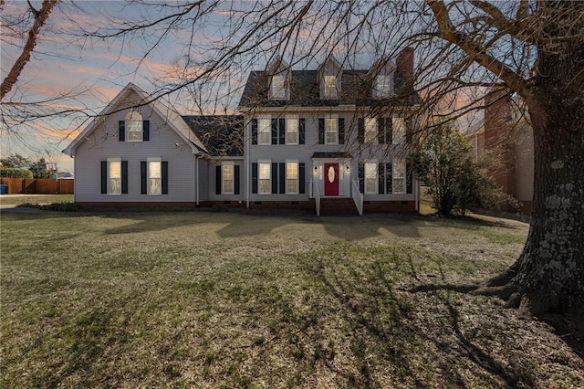 view of front facade featuring a front yard, crawl space, and a chimney