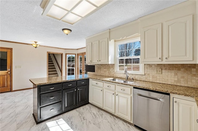 kitchen featuring a peninsula, a sink, marble finish floor, ornamental molding, and stainless steel dishwasher