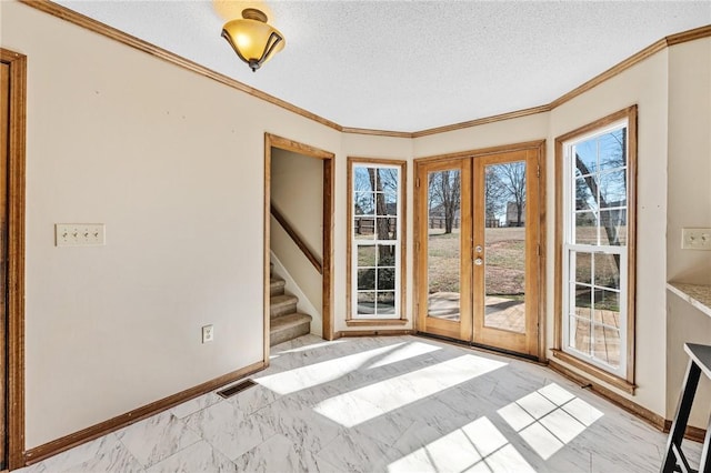 interior space with stairs, marble finish floor, ornamental molding, and a textured ceiling