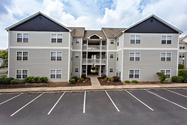 view of building exterior with uncovered parking