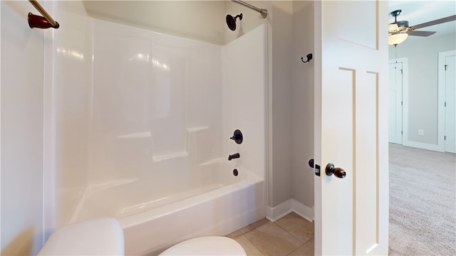 bathroom featuring toilet, shower / bathtub combination, baseboards, and tile patterned floors