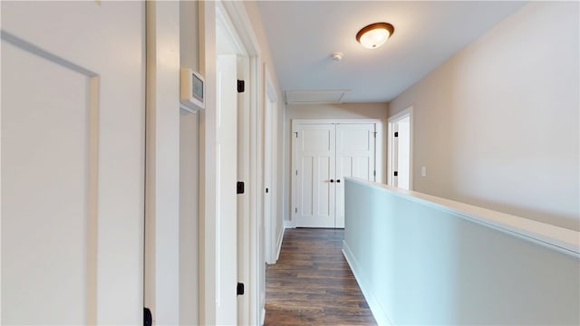 corridor featuring dark wood finished floors and baseboards