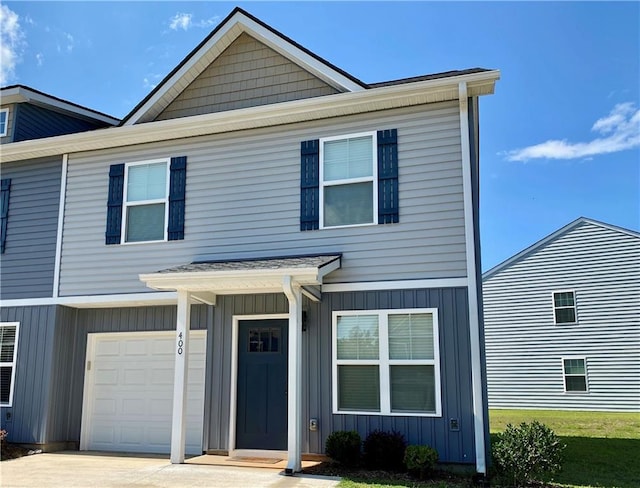 view of front of property with board and batten siding, concrete driveway, and an attached garage