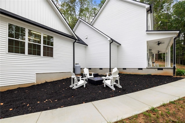 exterior space with a fire pit, ceiling fan, and crawl space