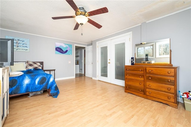 bedroom featuring wood finished floors, ceiling fan, french doors, a textured ceiling, and crown molding