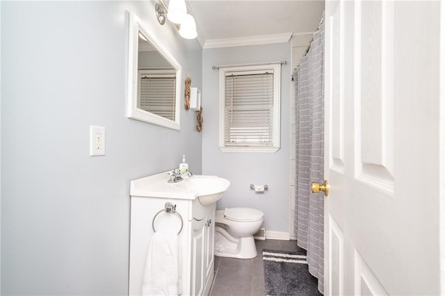 bathroom featuring tile patterned floors, toilet, ornamental molding, baseboards, and vanity