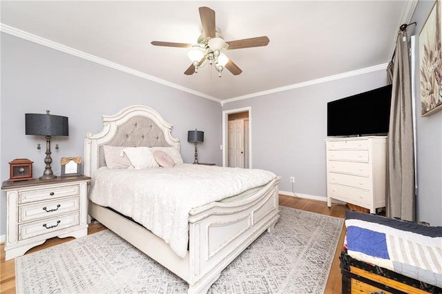 bedroom featuring ceiling fan, crown molding, baseboards, and wood finished floors