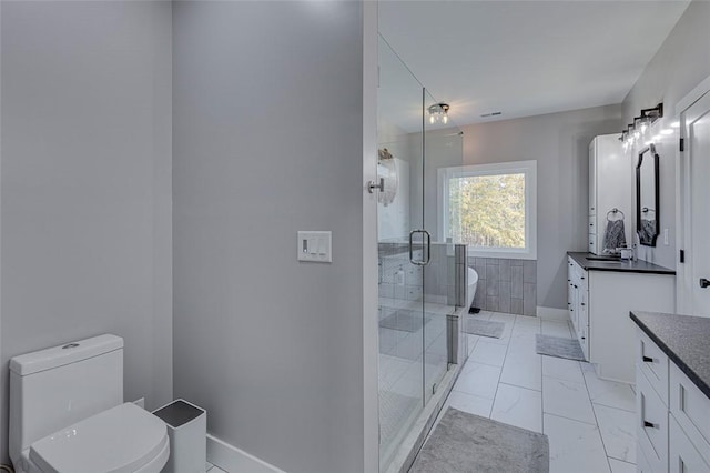 bathroom with marble finish floor, toilet, a shower stall, and vanity