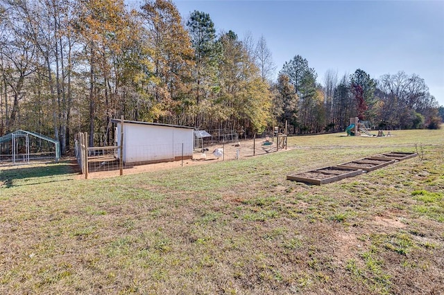 view of yard with a playground and fence