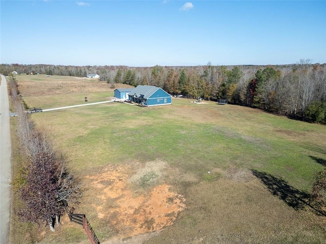 bird's eye view featuring a forest view and a rural view